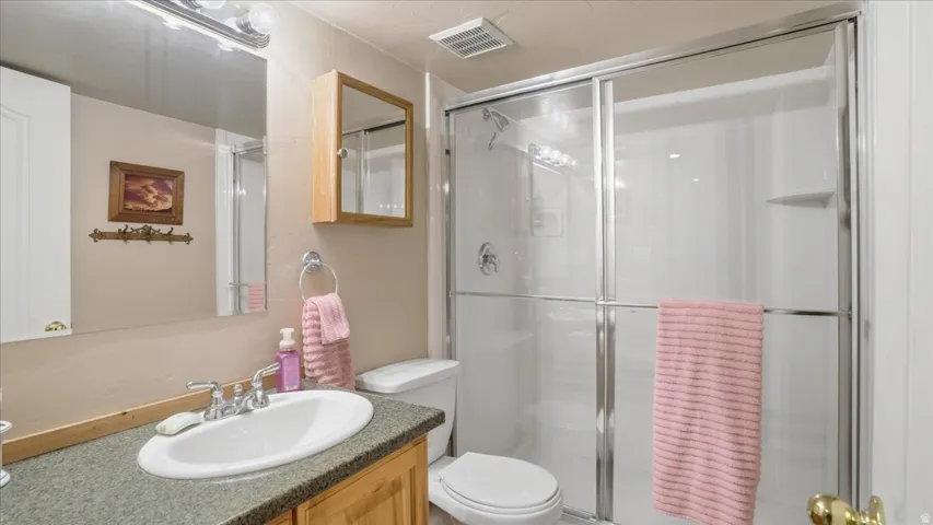 Full bath with vanity and a stall shower