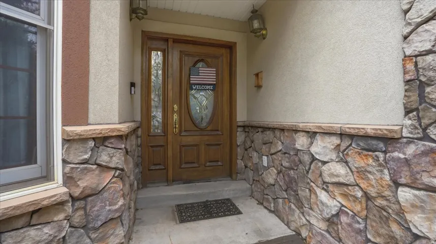 Property entrance with stone siding