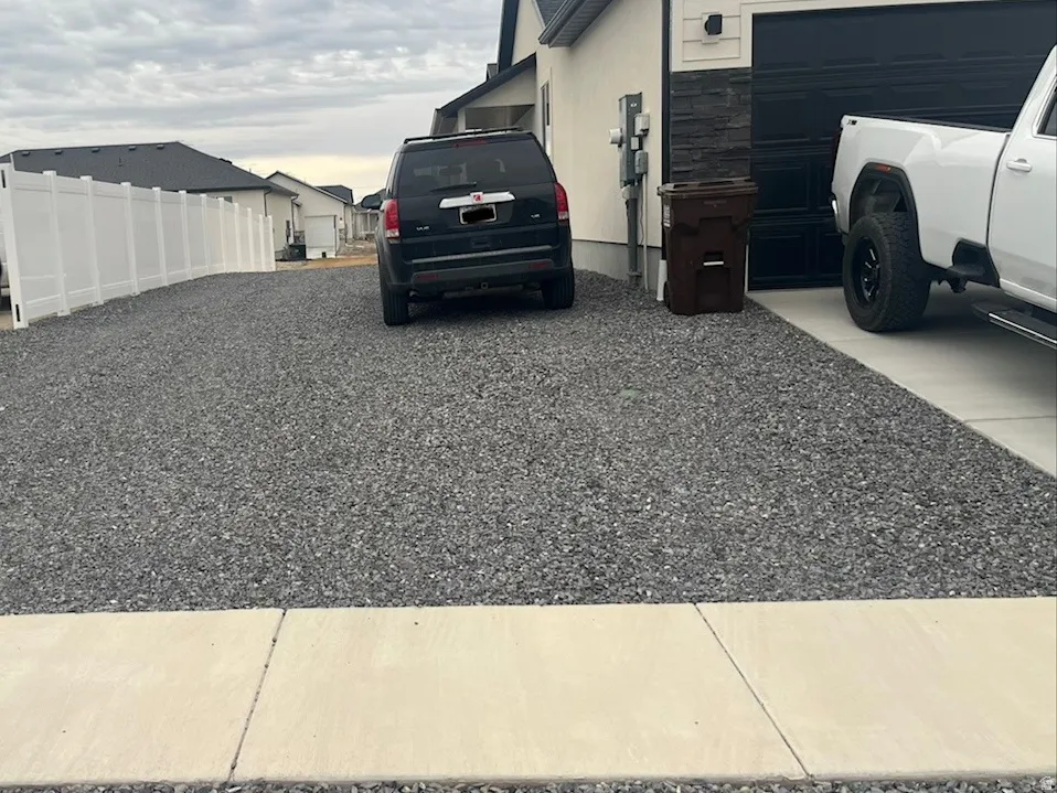 View of side of home featuring stone siding and driveway