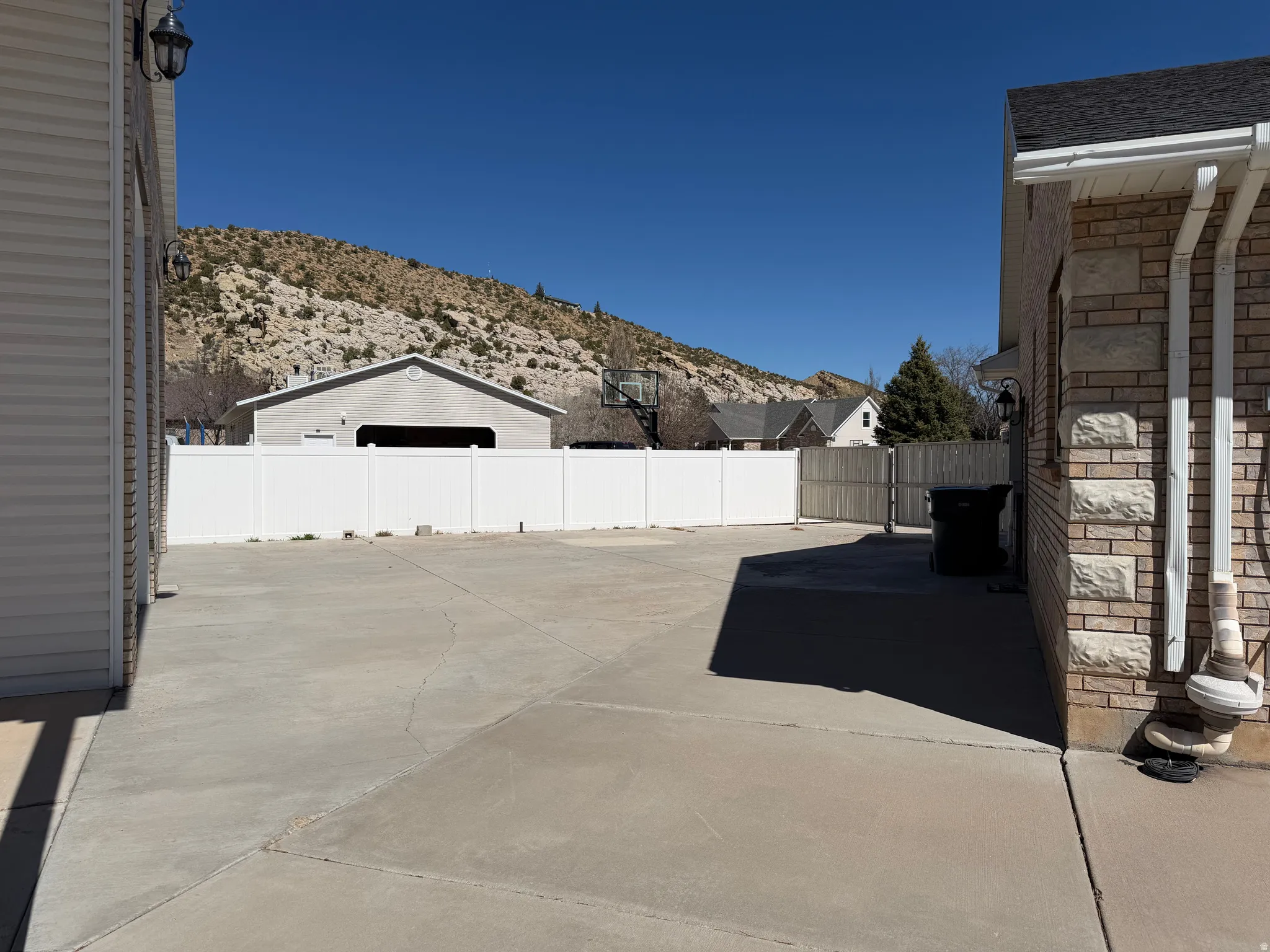 Fenced backyard featuring a mountain view and a patio area
