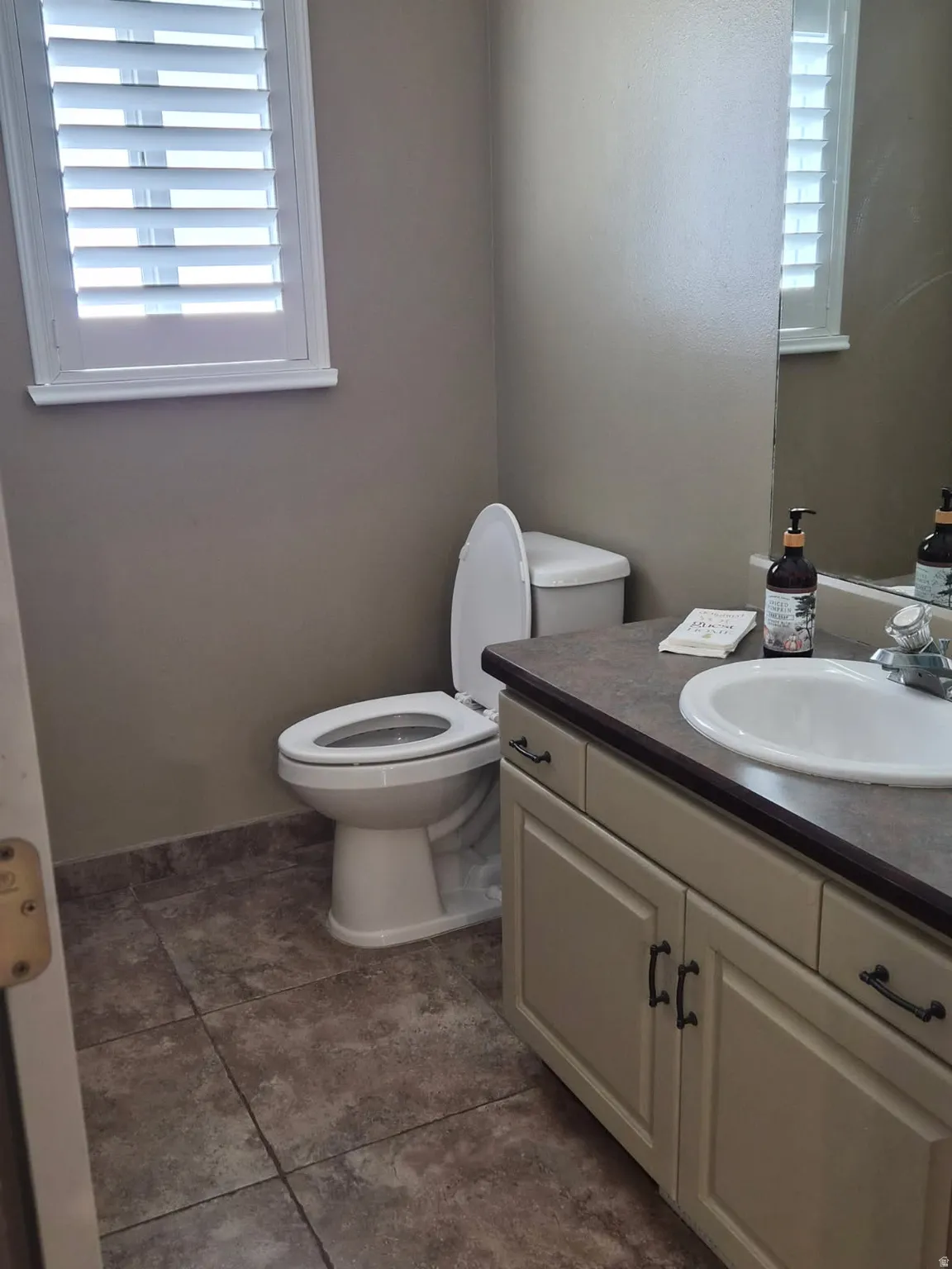 Half bathroom featuring toilet and vanity
