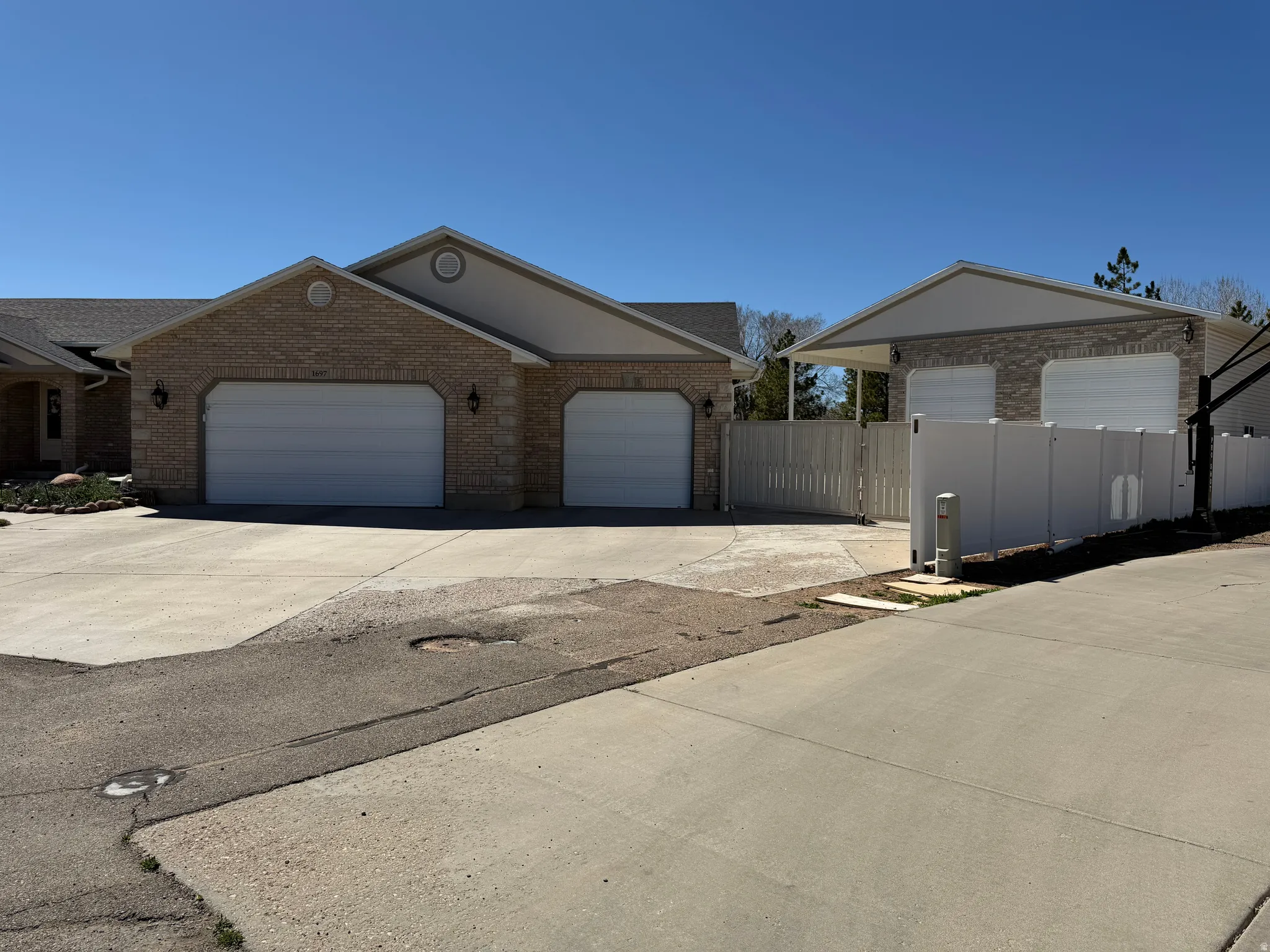 View of front of home featuring concrete driveway, a garage, and brick siding