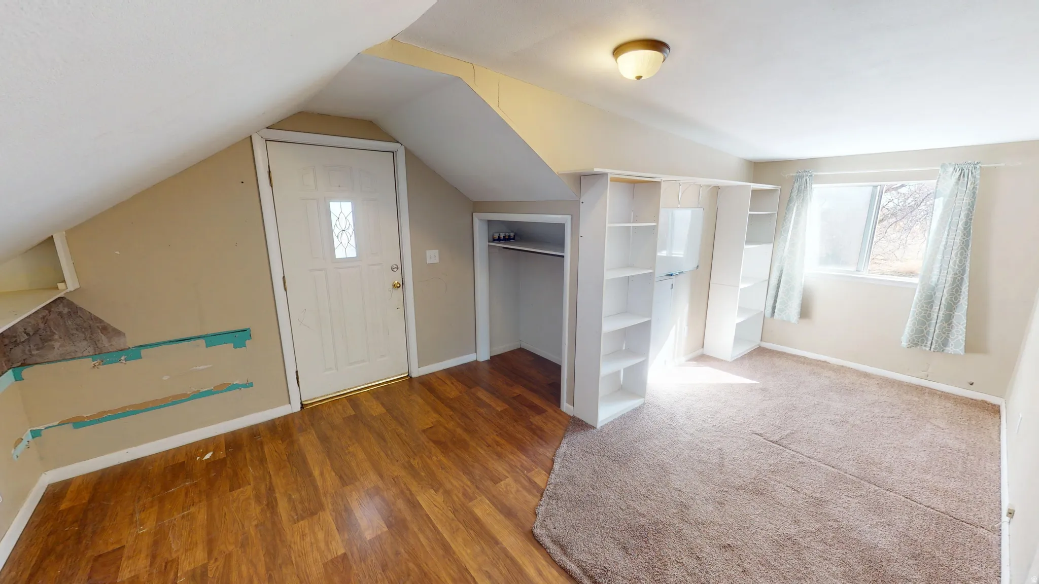 Additional living space with baseboards and wood finished floors