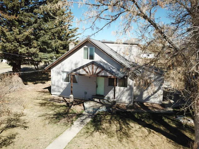 Back of house featuring a chimney