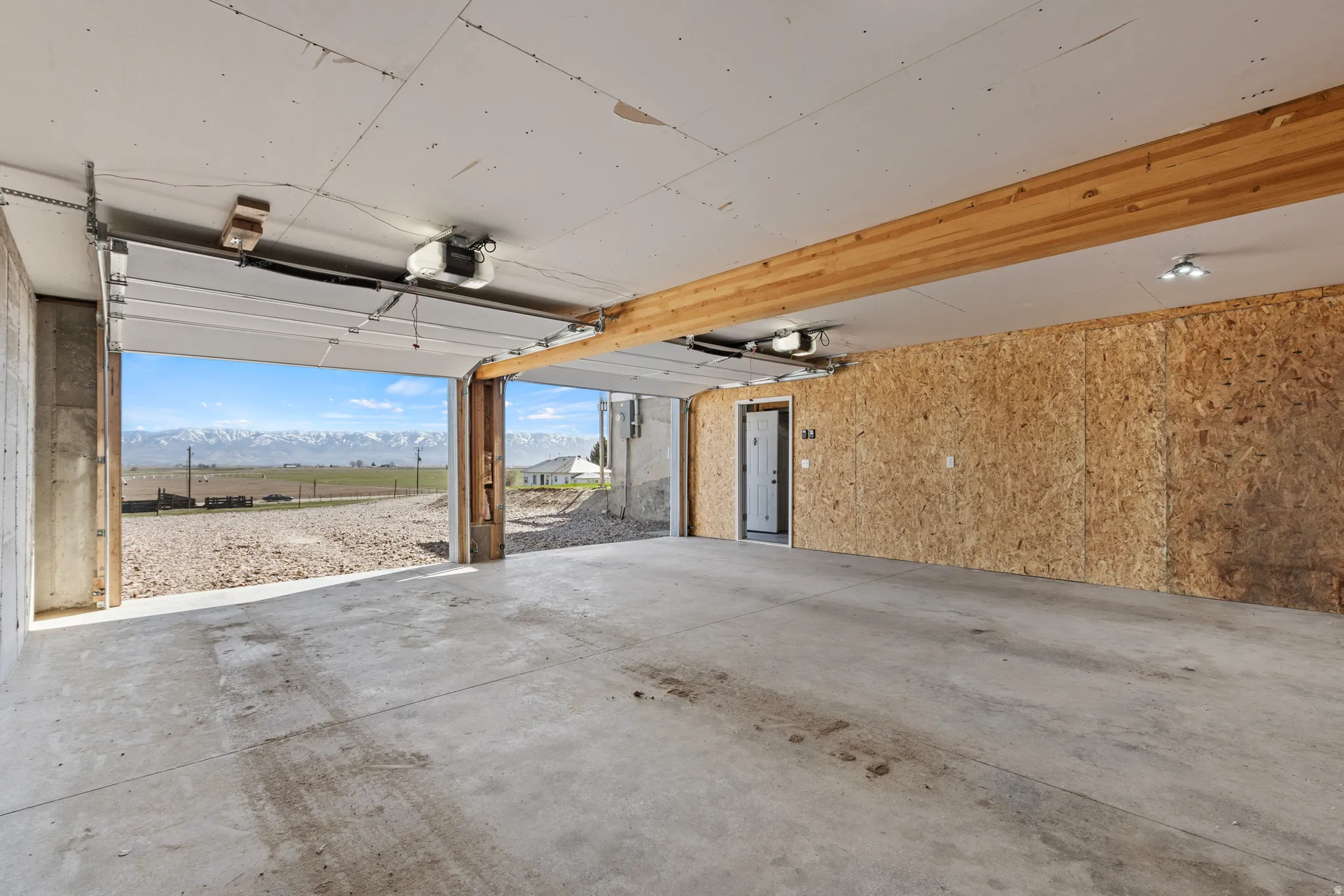 Garage featuring a mountain view and a garage door opener
