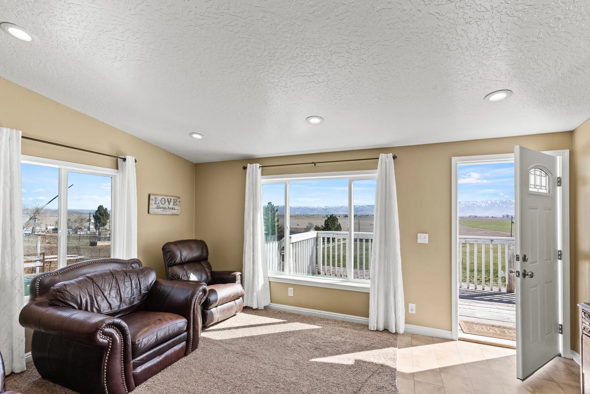 Living area featuring recessed lighting, carpet, and tile patterned flooring