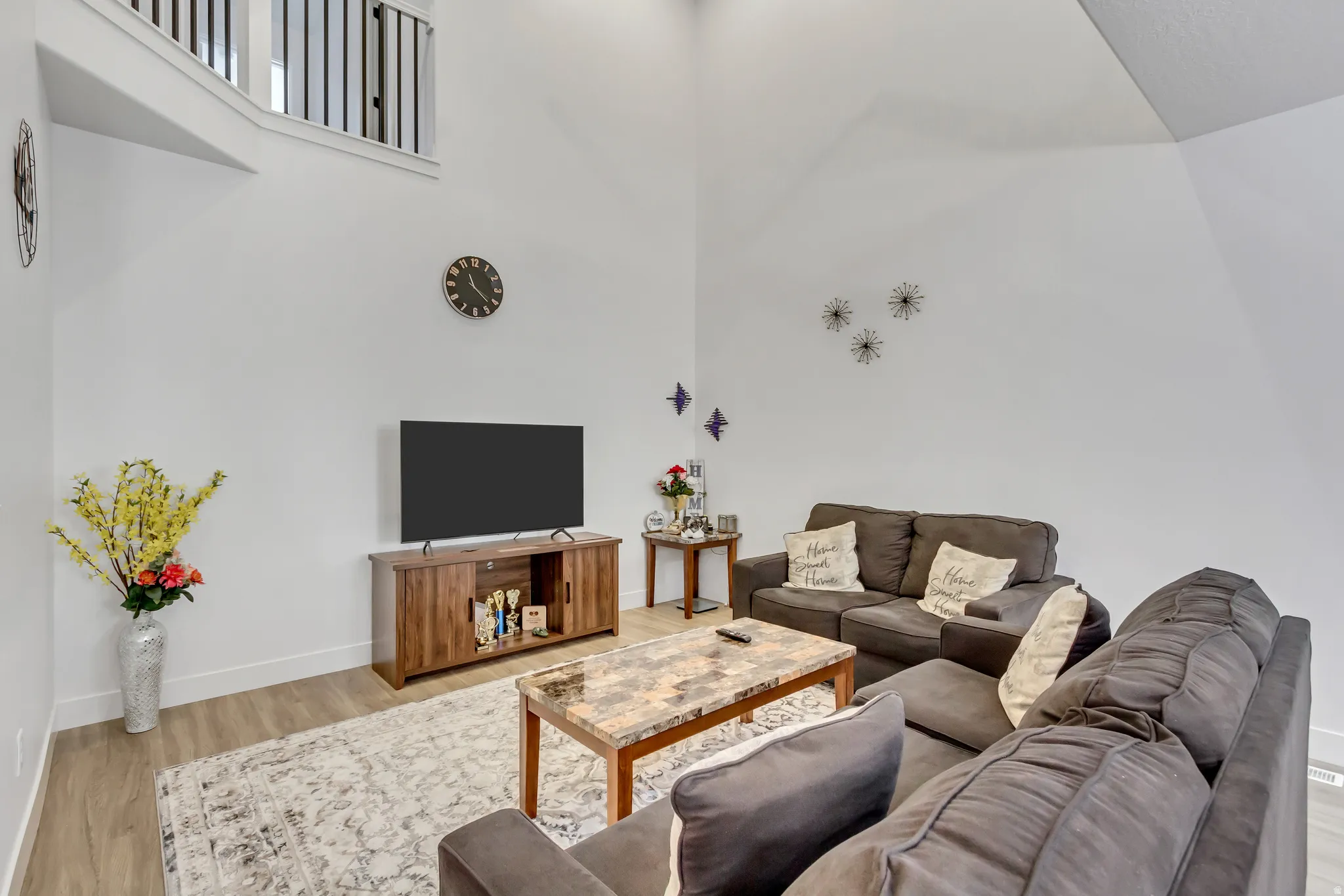 Living room featuring wood finished floors and a high ceiling