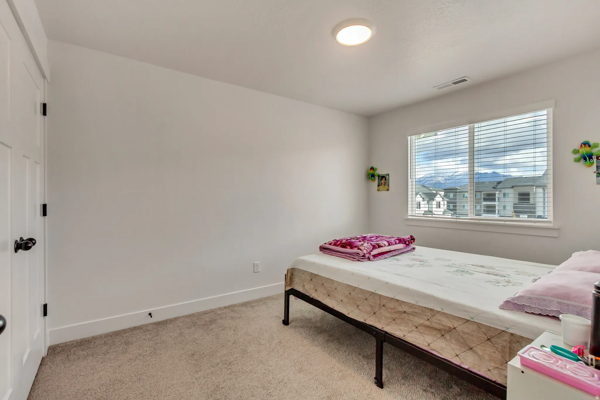 Bedroom with carpet floors and baseboards