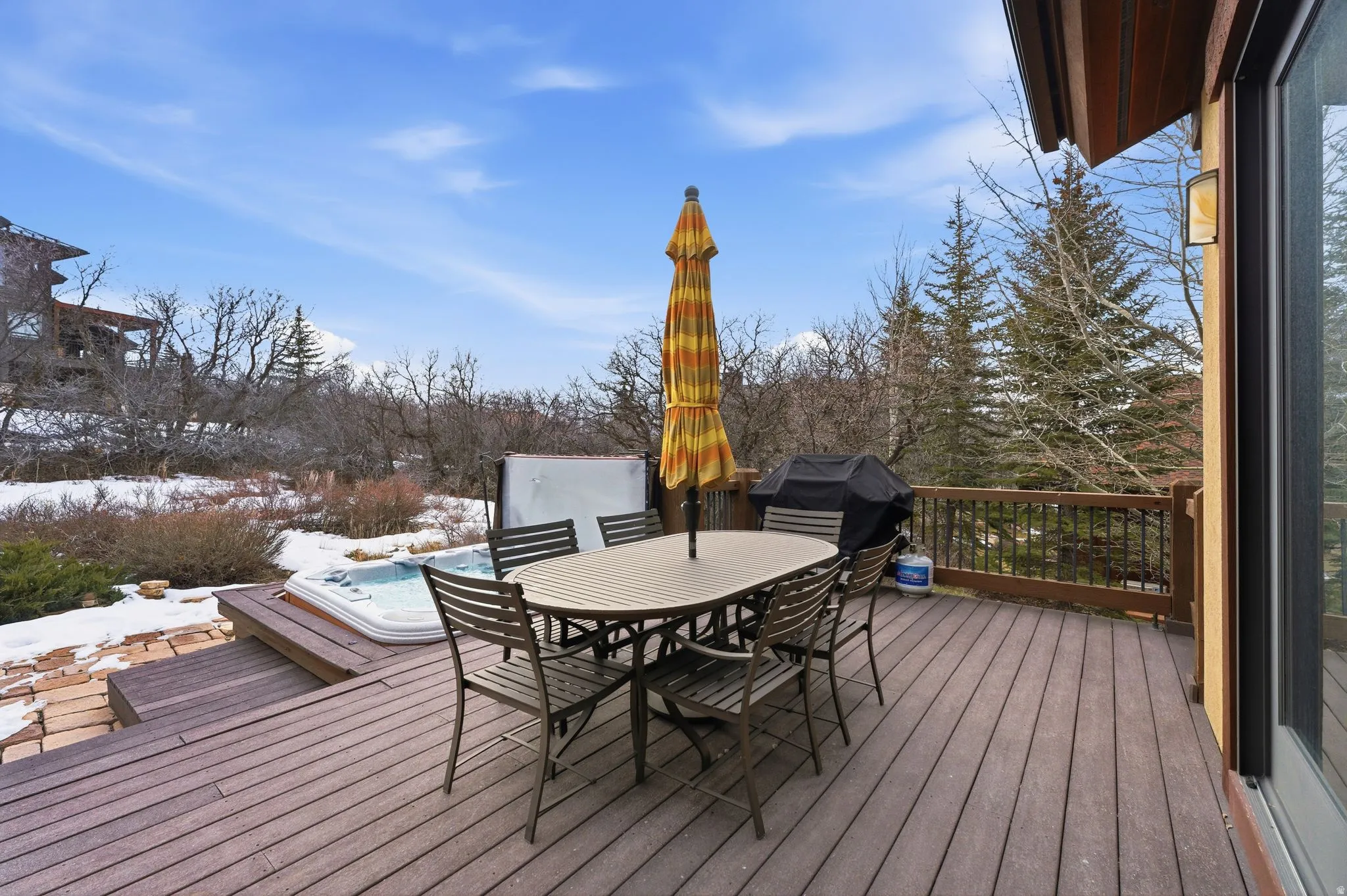 Wooden deck with outdoor dining area and a grill