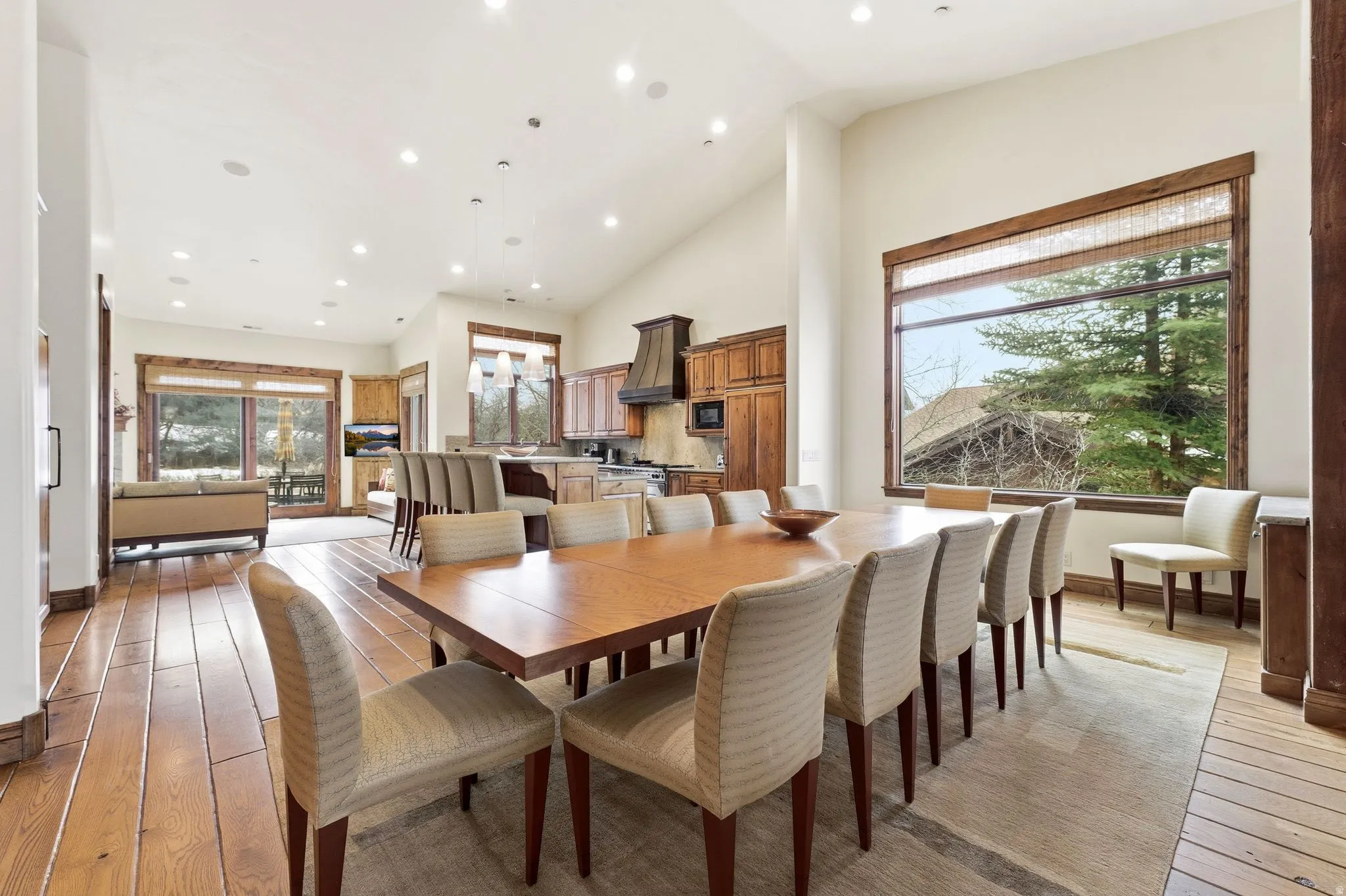 Dining room with light wood finished floors, recessed lighting, and vaulted ceiling
