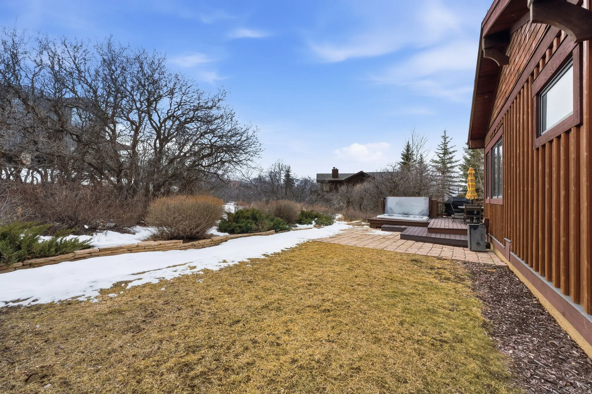View of grassy yard featuring a deck