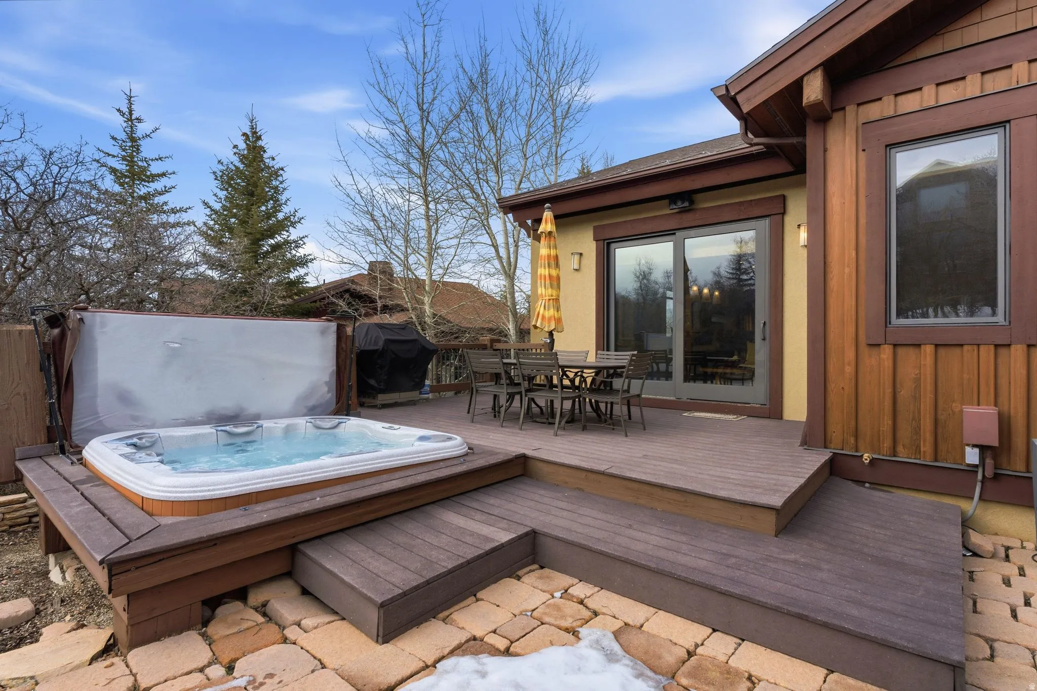 Deck with outdoor dining area and a grill