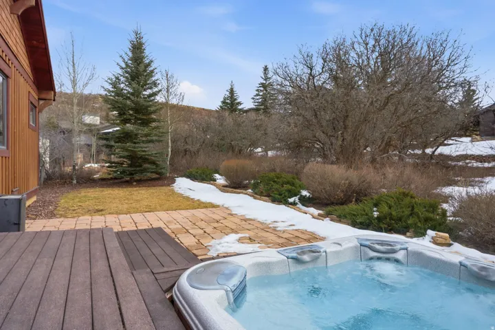 Snow covered pool with a wooden deck