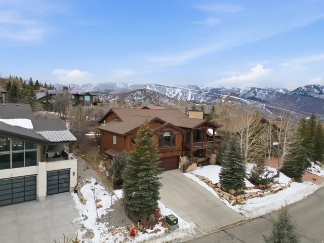 View of front facade featuring concrete driveway, an attached garage, a mountain view, and a balcony