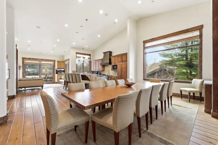 Dining room with light wood finished floors, recessed lighting, and vaulted ceiling