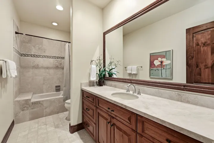 Bathroom featuring vanity, tiled shower / bath, and recessed lighting