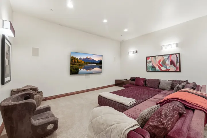 Carpeted home theater with baseboards and recessed lighting