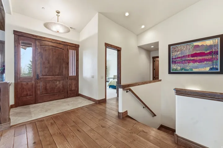 Foyer with light wood-type flooring and lofted ceiling