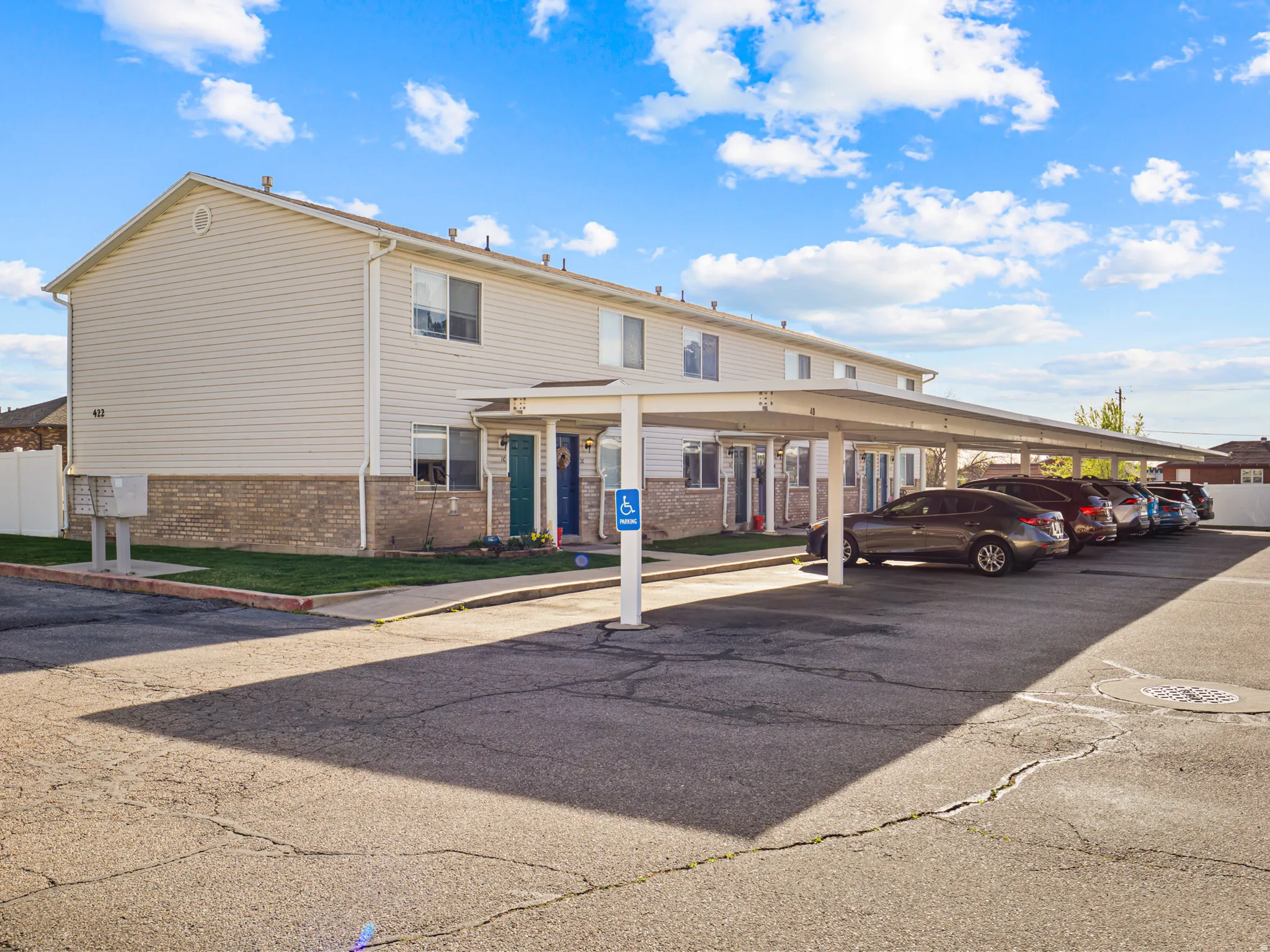 View of front of home with brick siding and covered parking