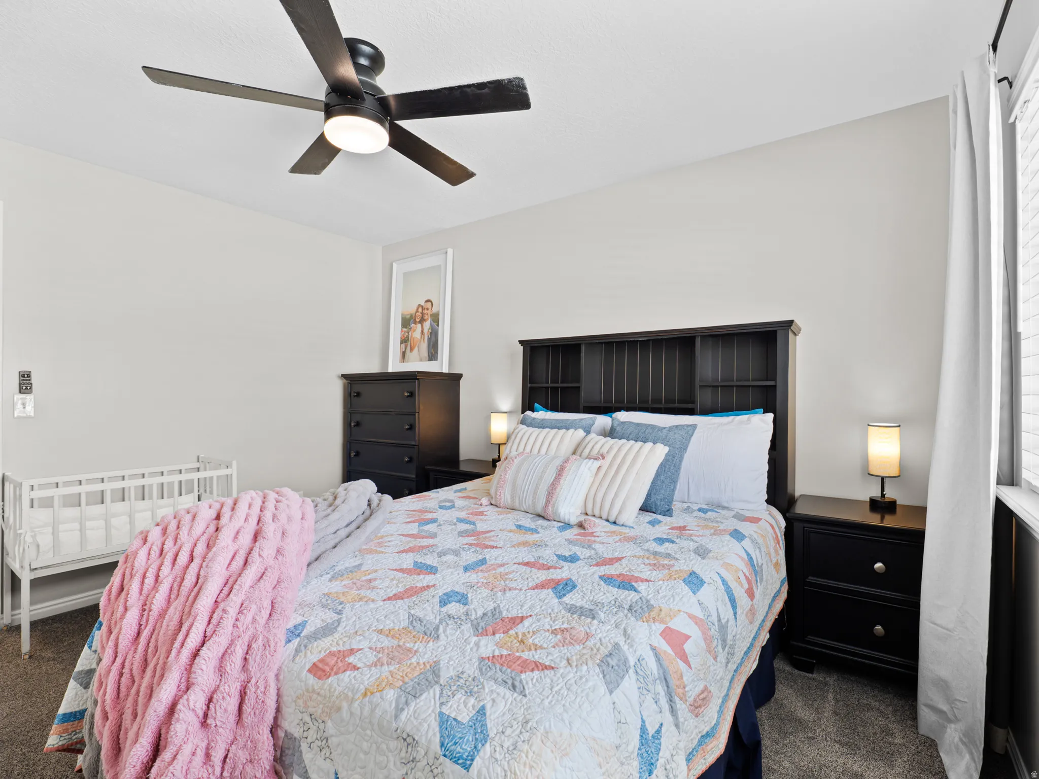 Bedroom featuring dark carpet and ceiling fan