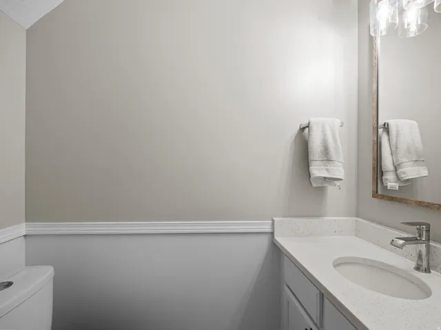 Half bathroom featuring vanity and toilet