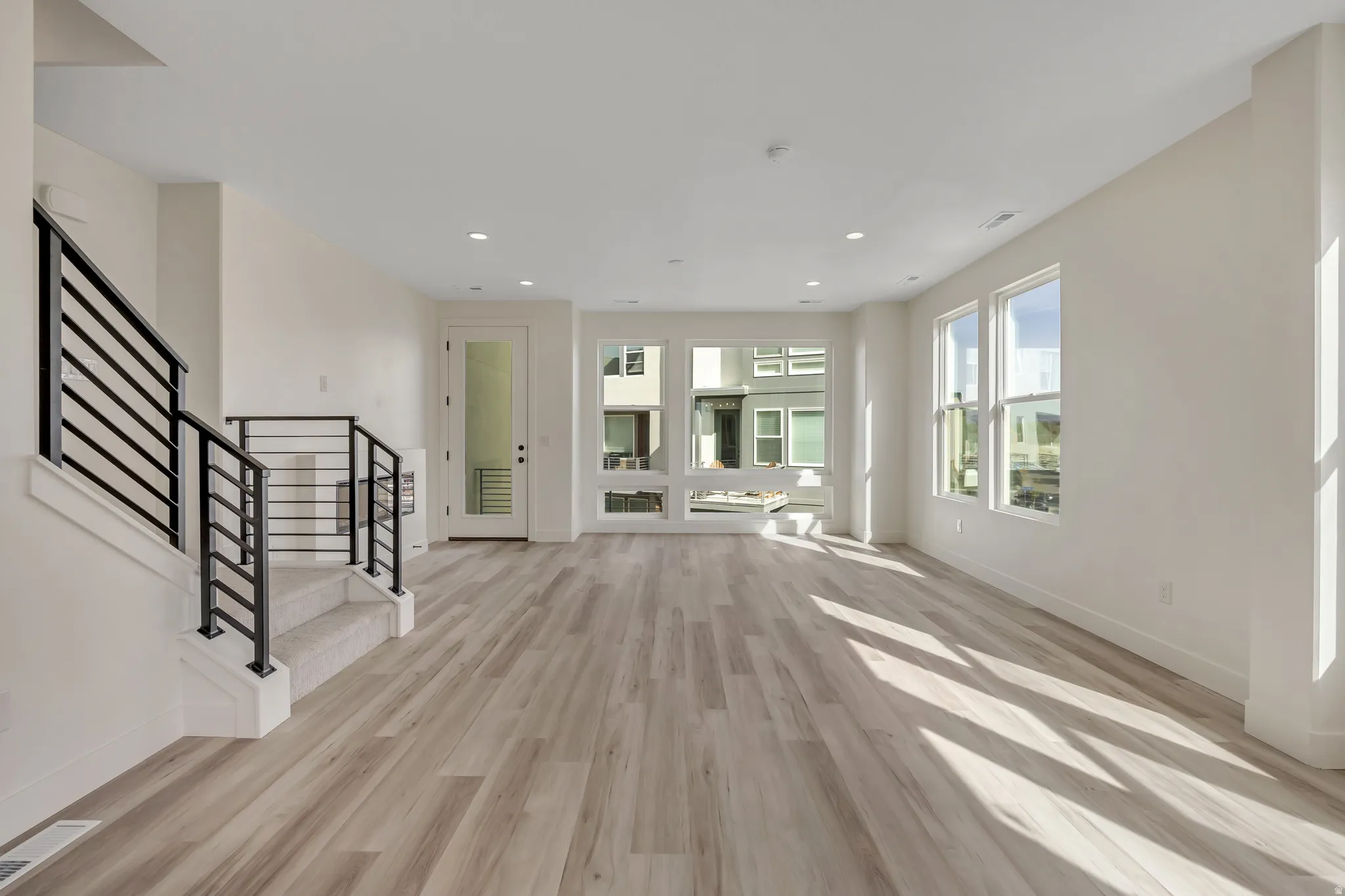 Unfurnished living room featuring light wood-style flooring and recessed lighting