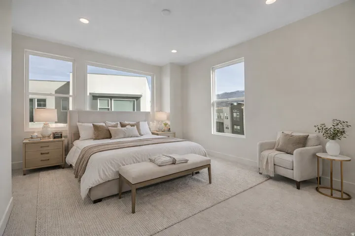 Bedroom with light carpet and recessed lighting