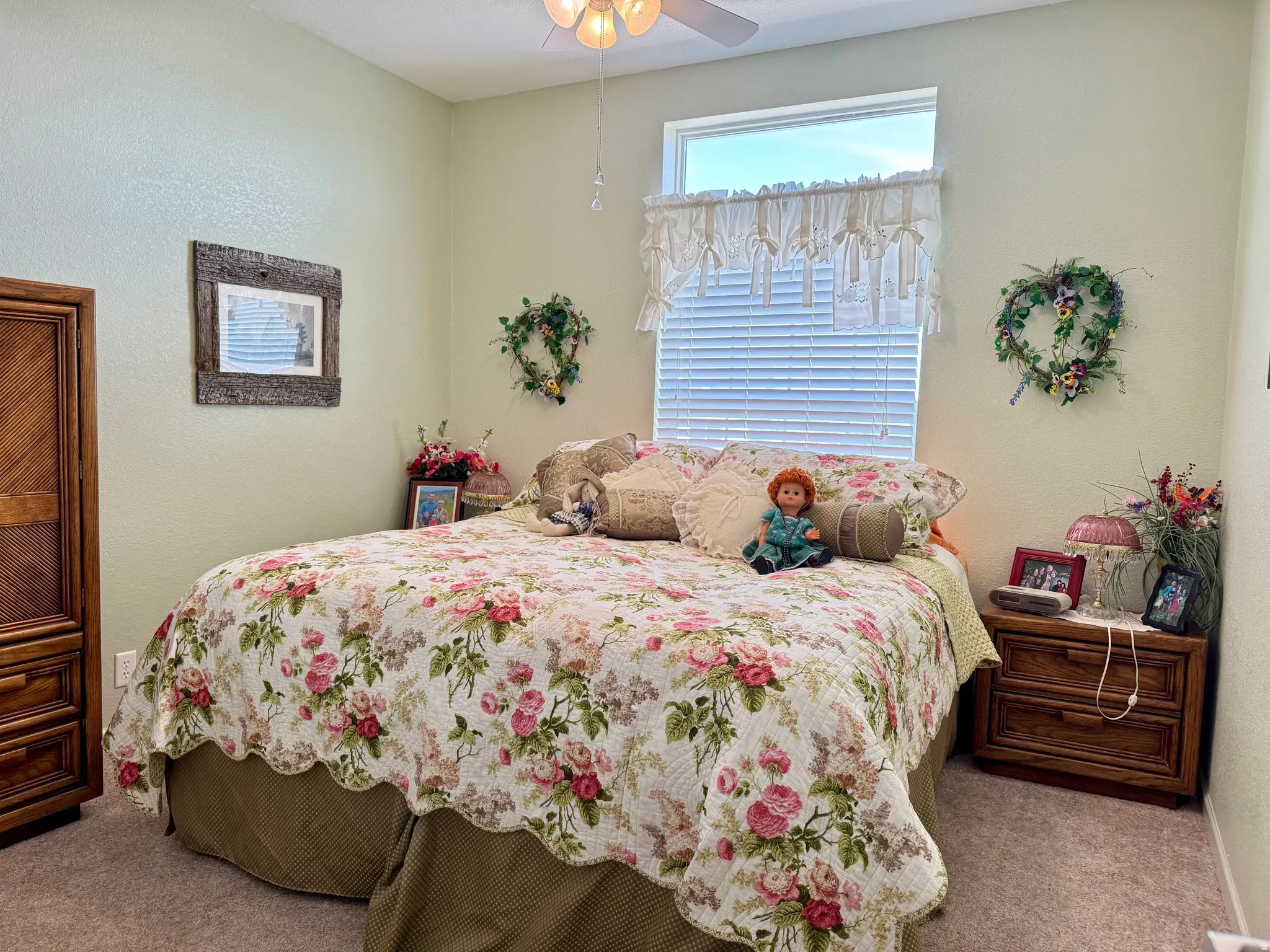 Bedroom featuring carpet, a textured wall, and a ceiling fan