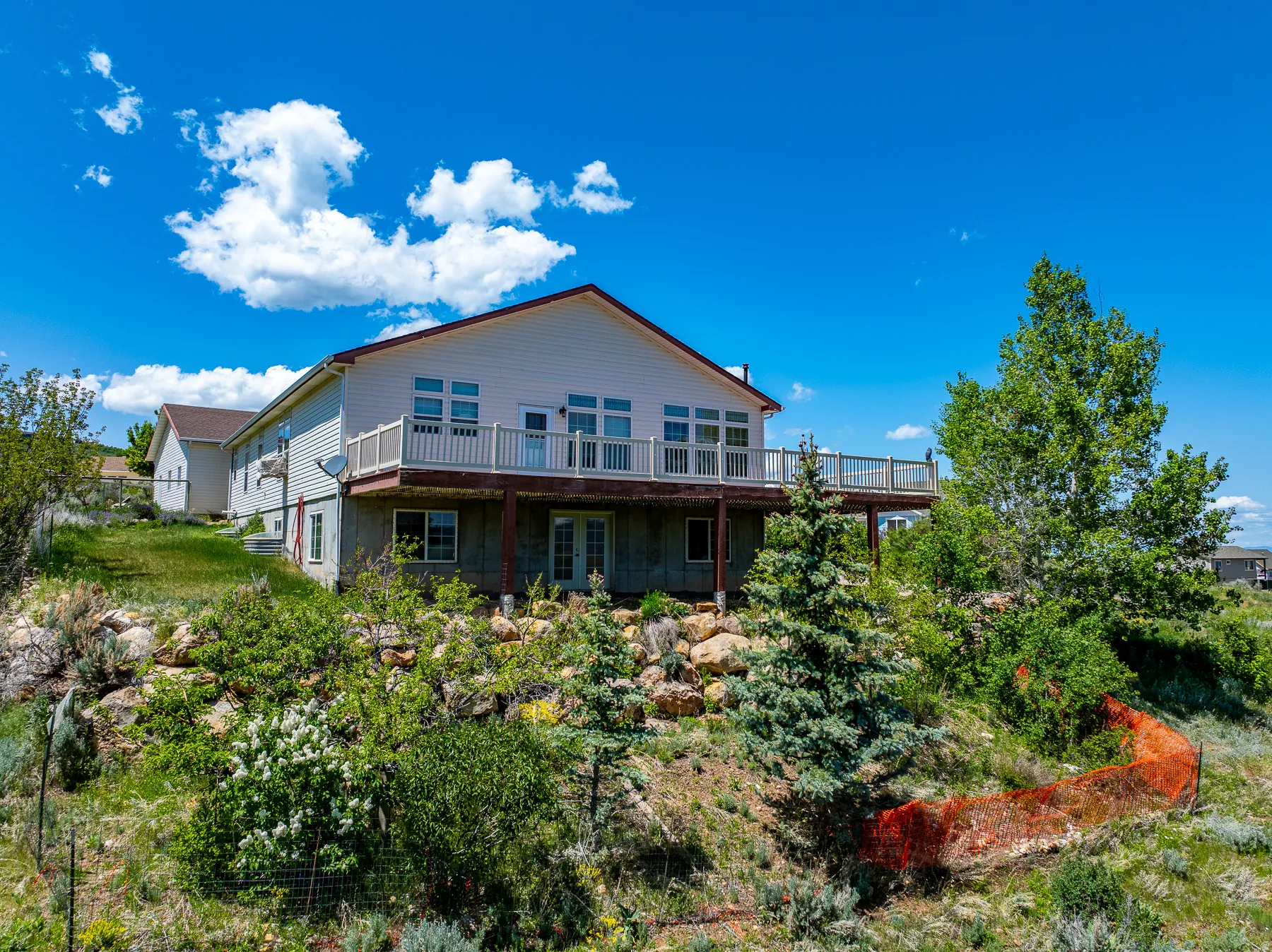 side view of house featuring a deck