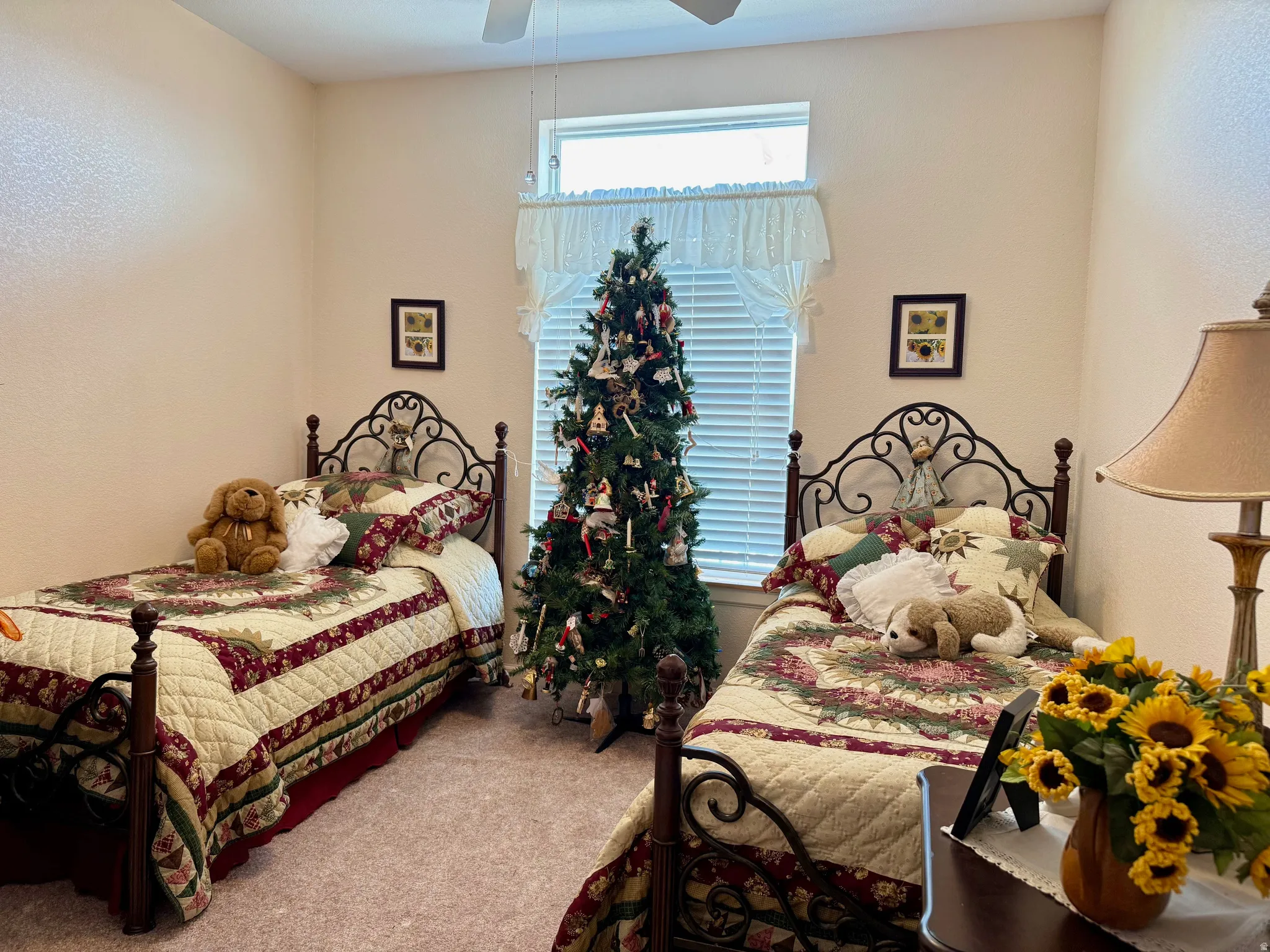 Carpeted bedroom featuring ceiling fan and a textured wall