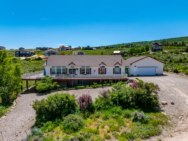 Single story home with driveway and a garage