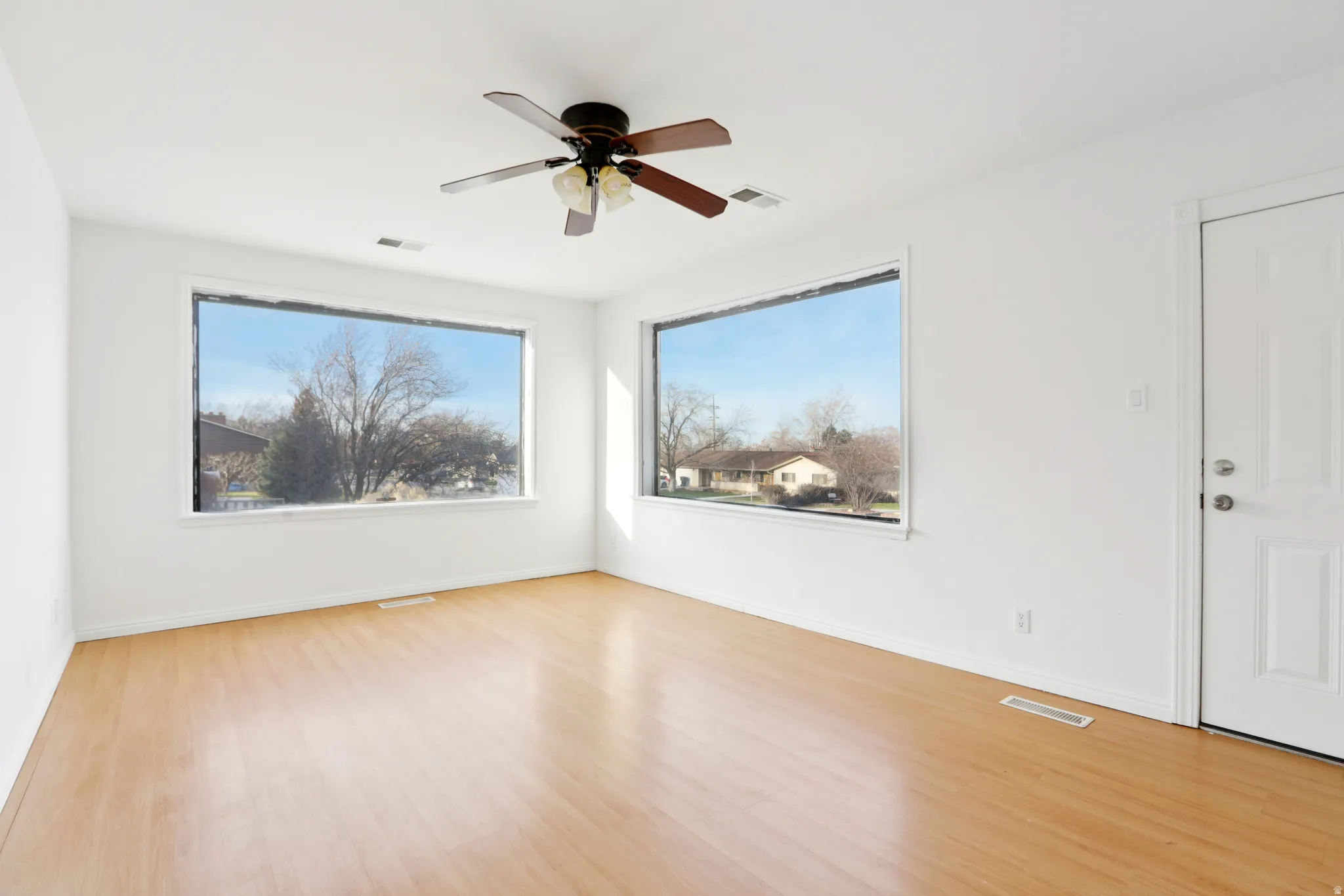 Spare room with ceiling fan and light wood finished floors