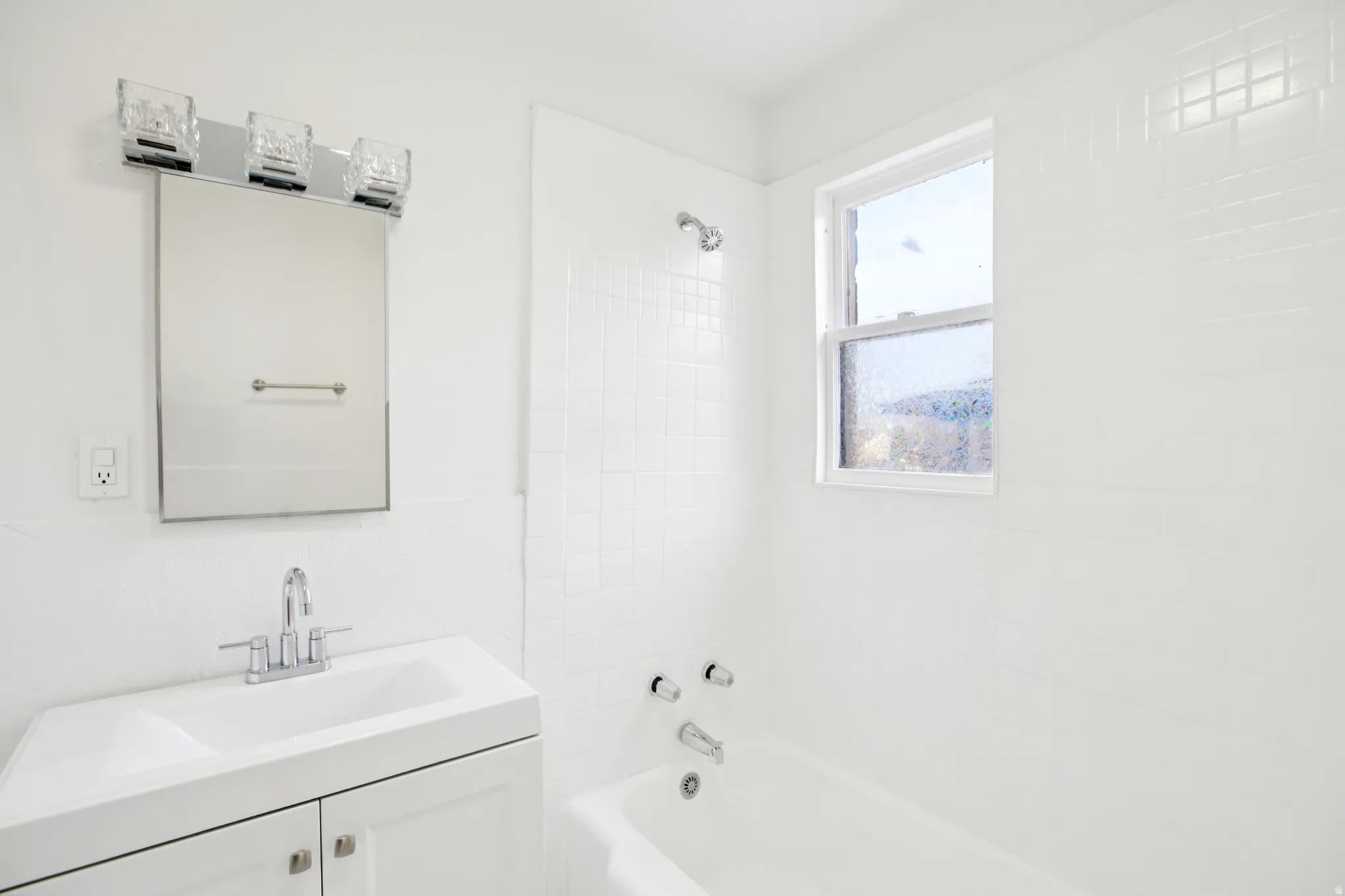 Bathroom with vanity and  shower combination