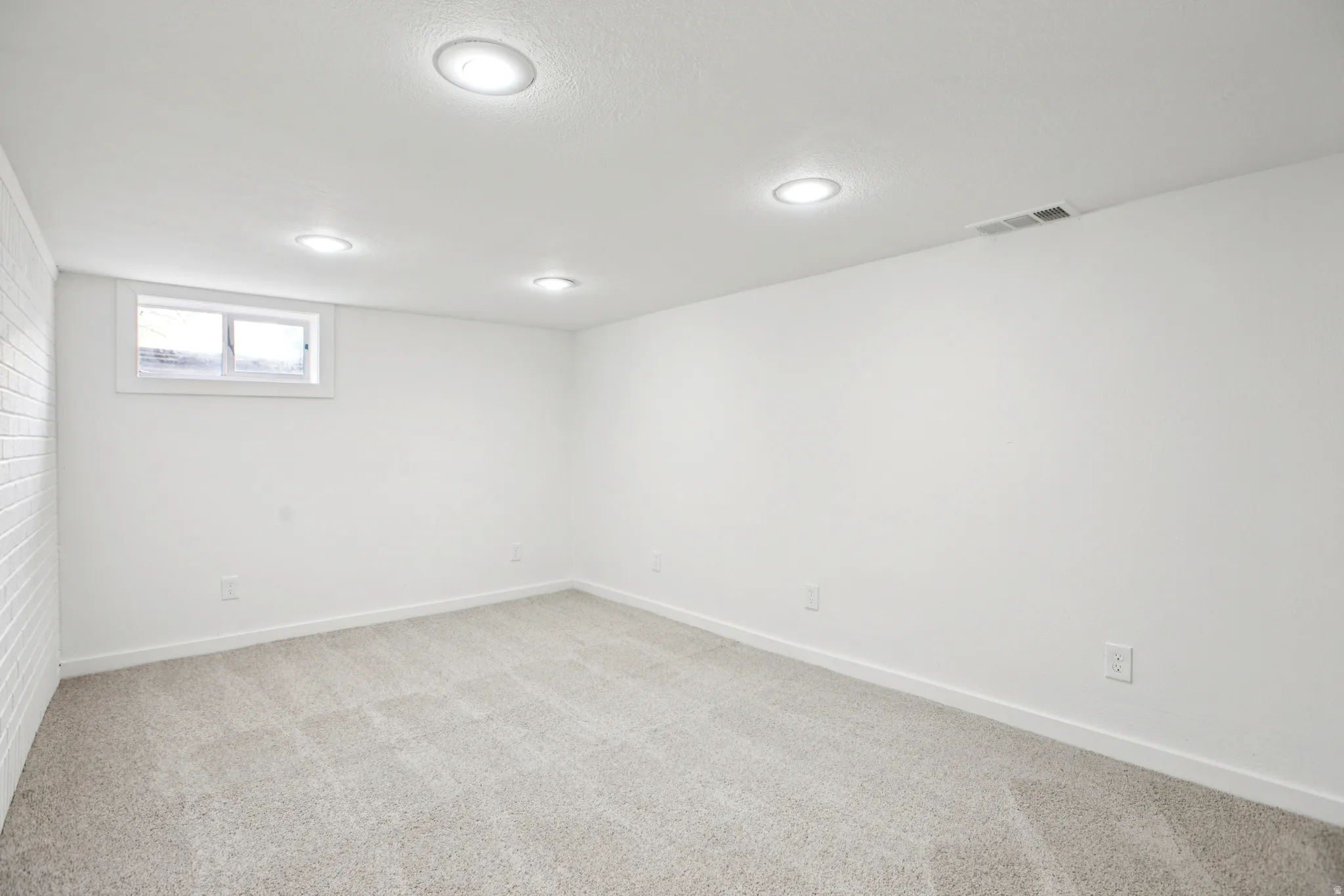 Below grade area with baseboards and light carpet