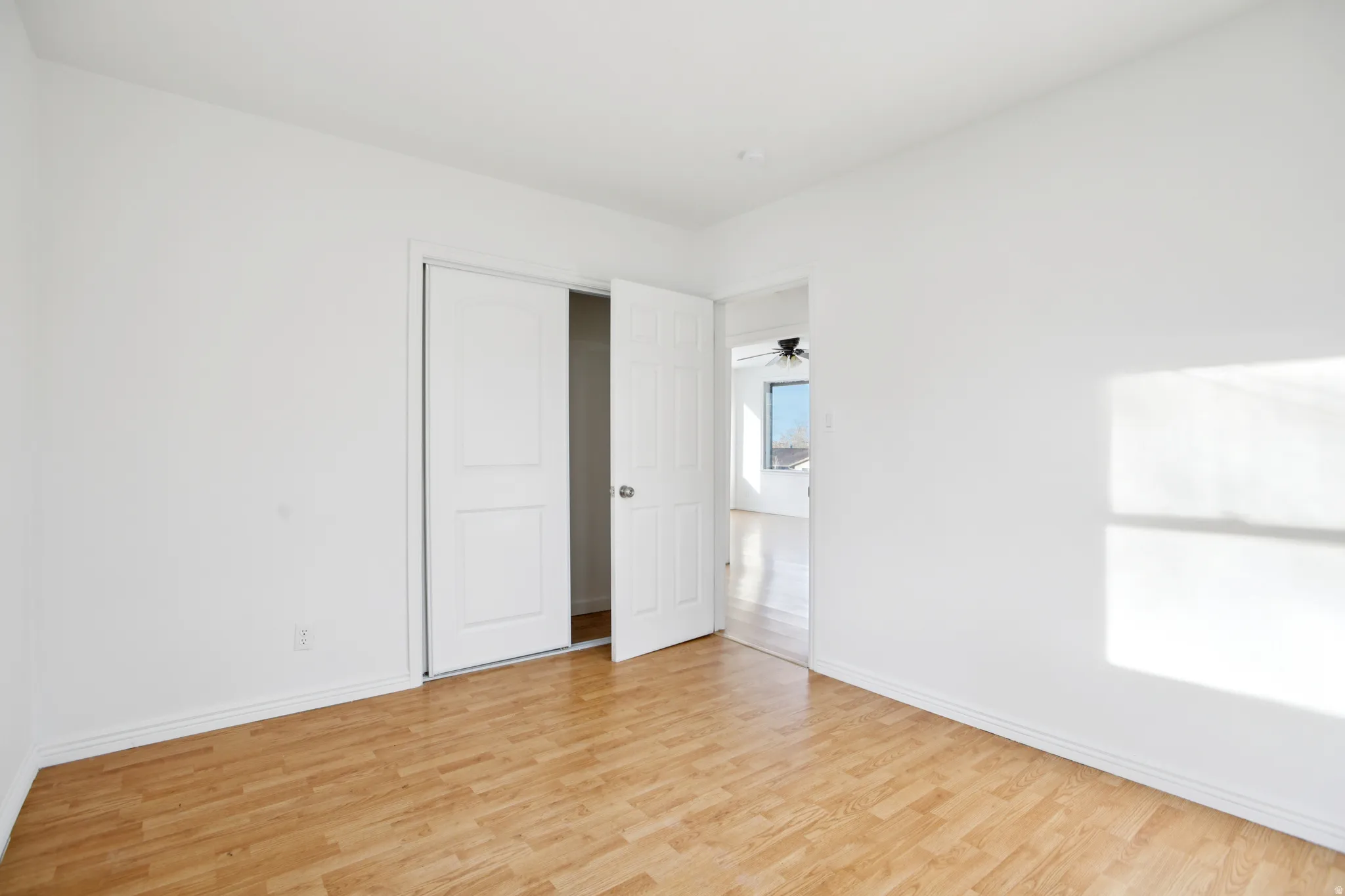 Unfurnished bedroom featuring light wood finished floors and baseboards