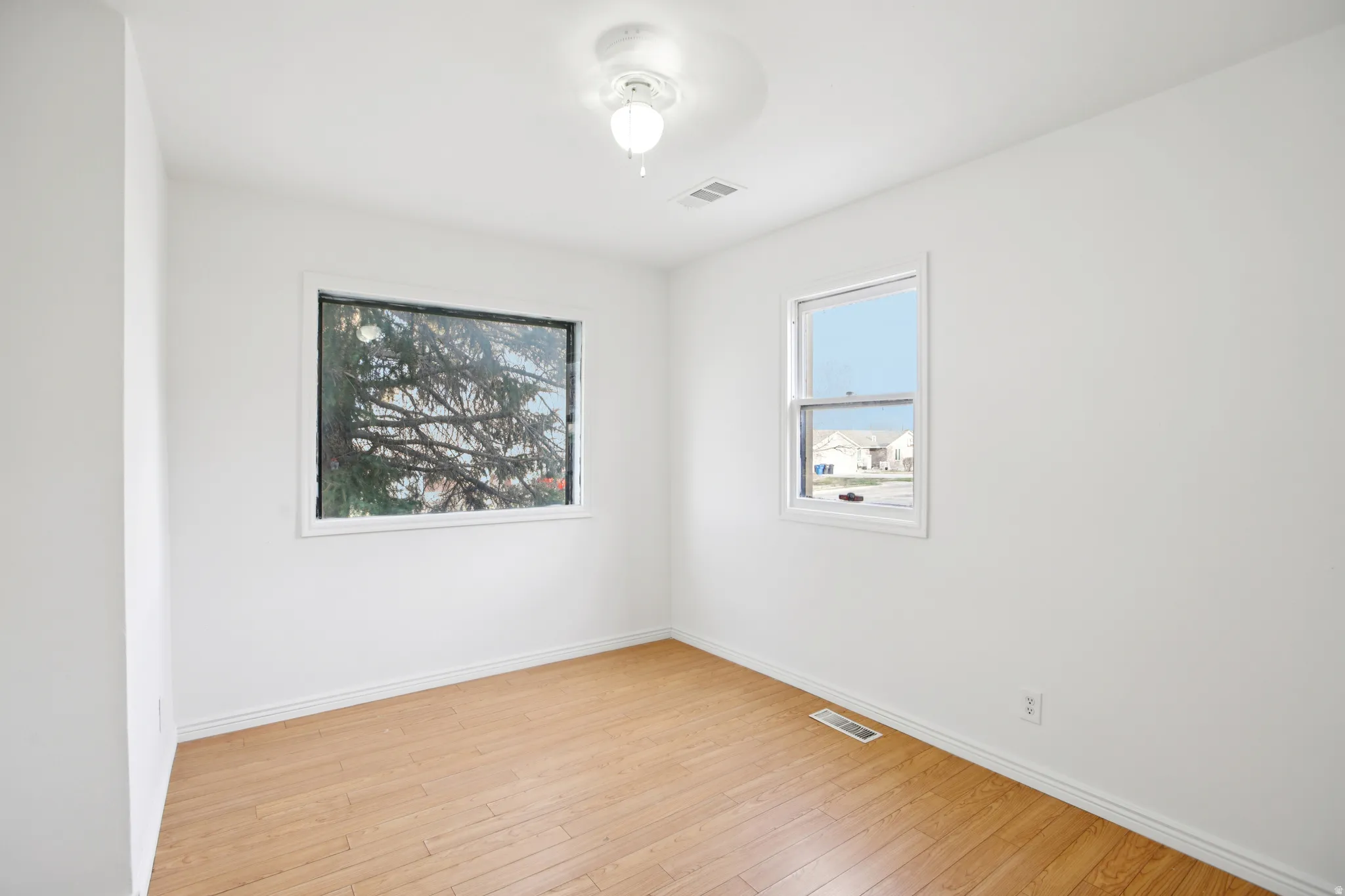 Spare room with light wood finished floors and baseboards