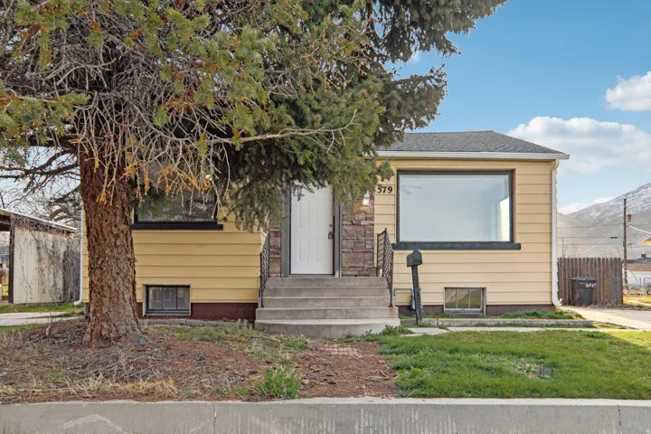View of front of property with a mountain view and roof with shingles