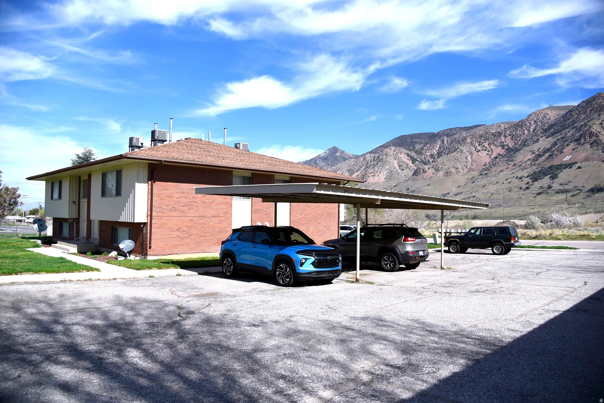 View of side of 4-Plex with covered and uncovered parking