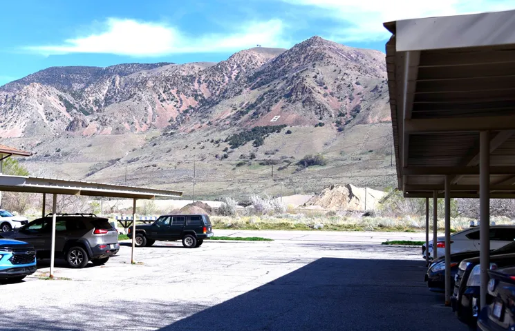 Covered parking lot featuring a mountain view