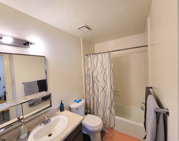 Full bathroom with vanity, shower / bath combo
