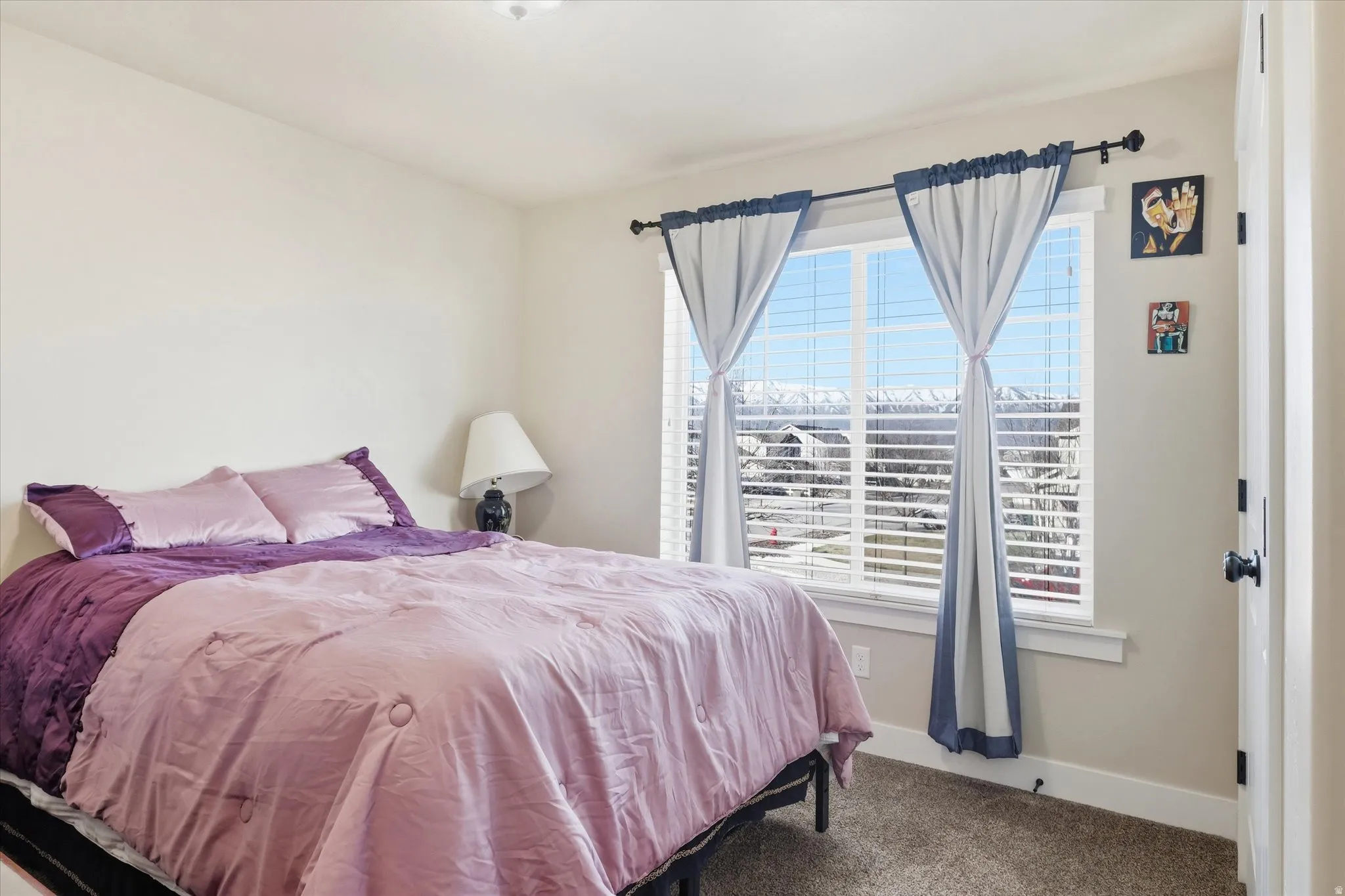 Bedroom with carpet flooring and baseboards
