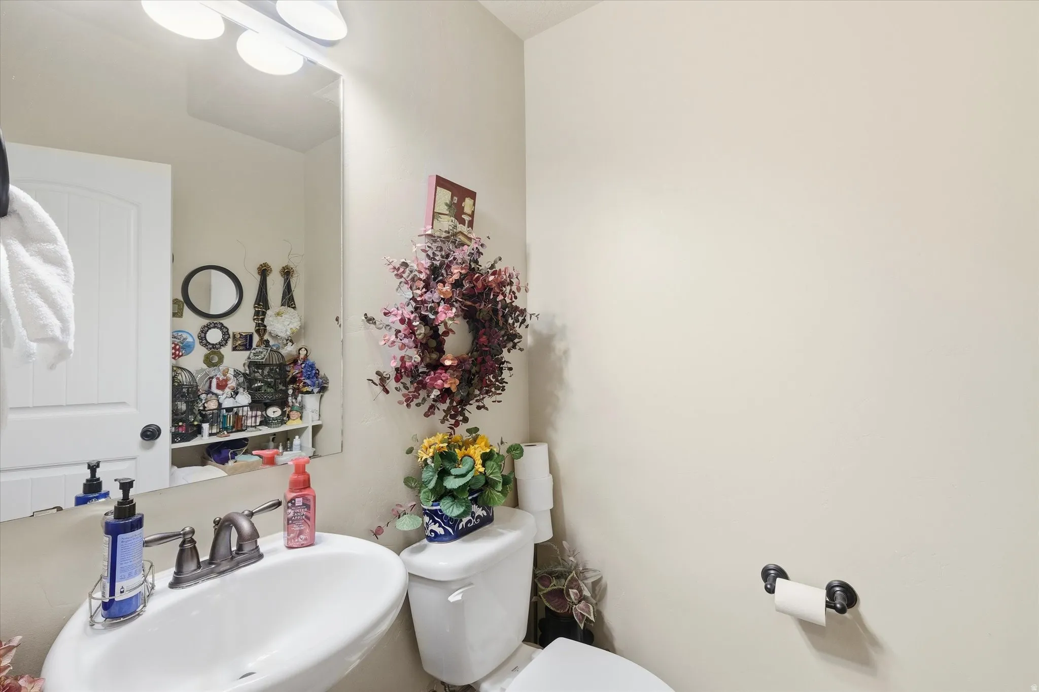 Half bathroom featuring a sink and toilet