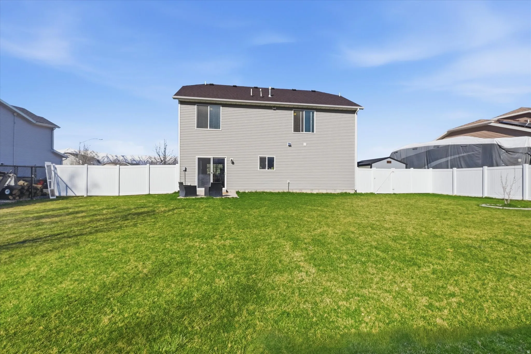 Rear view of property with a fenced backyard