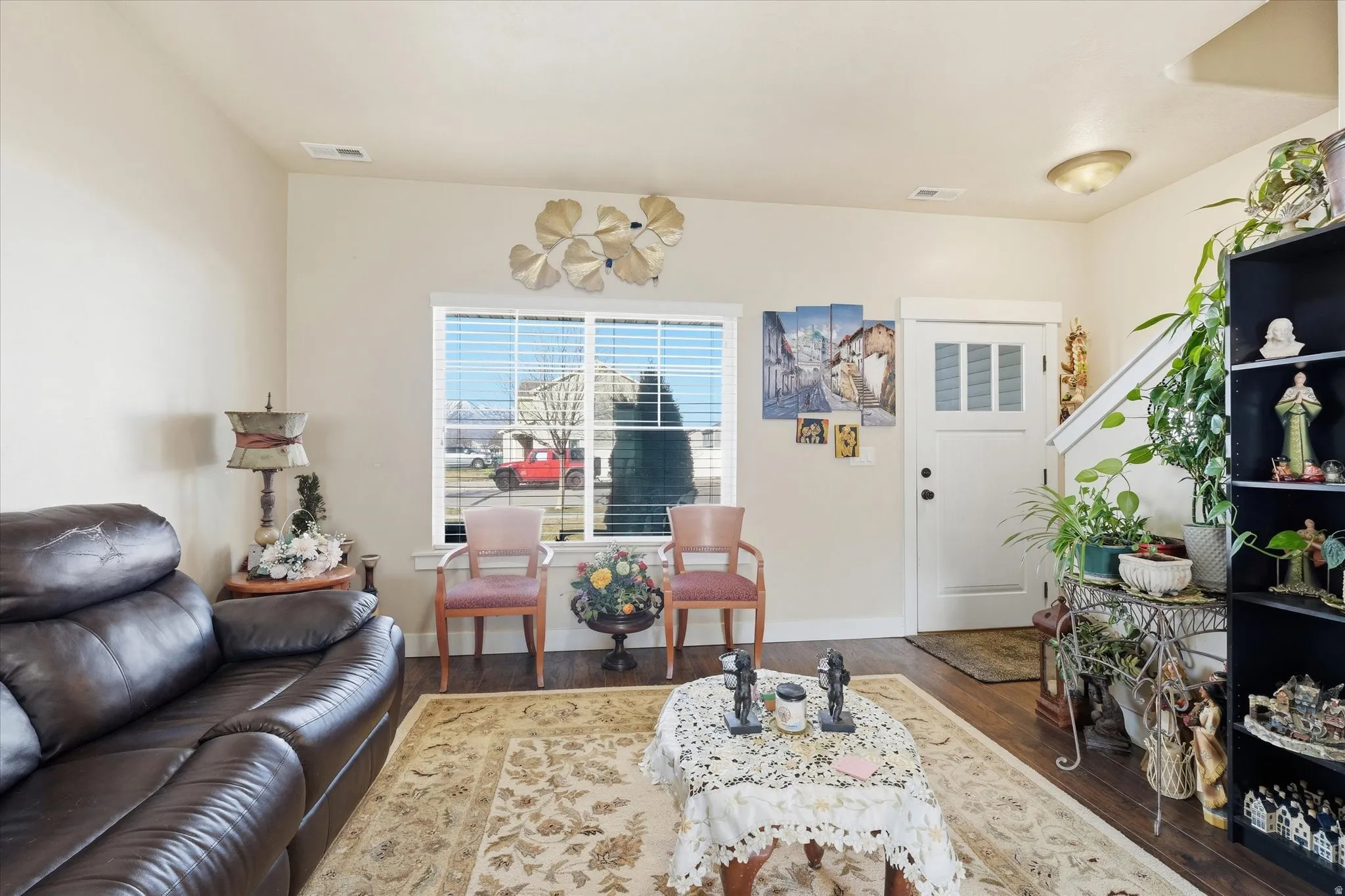 Living area with dark wood finished floors and baseboards