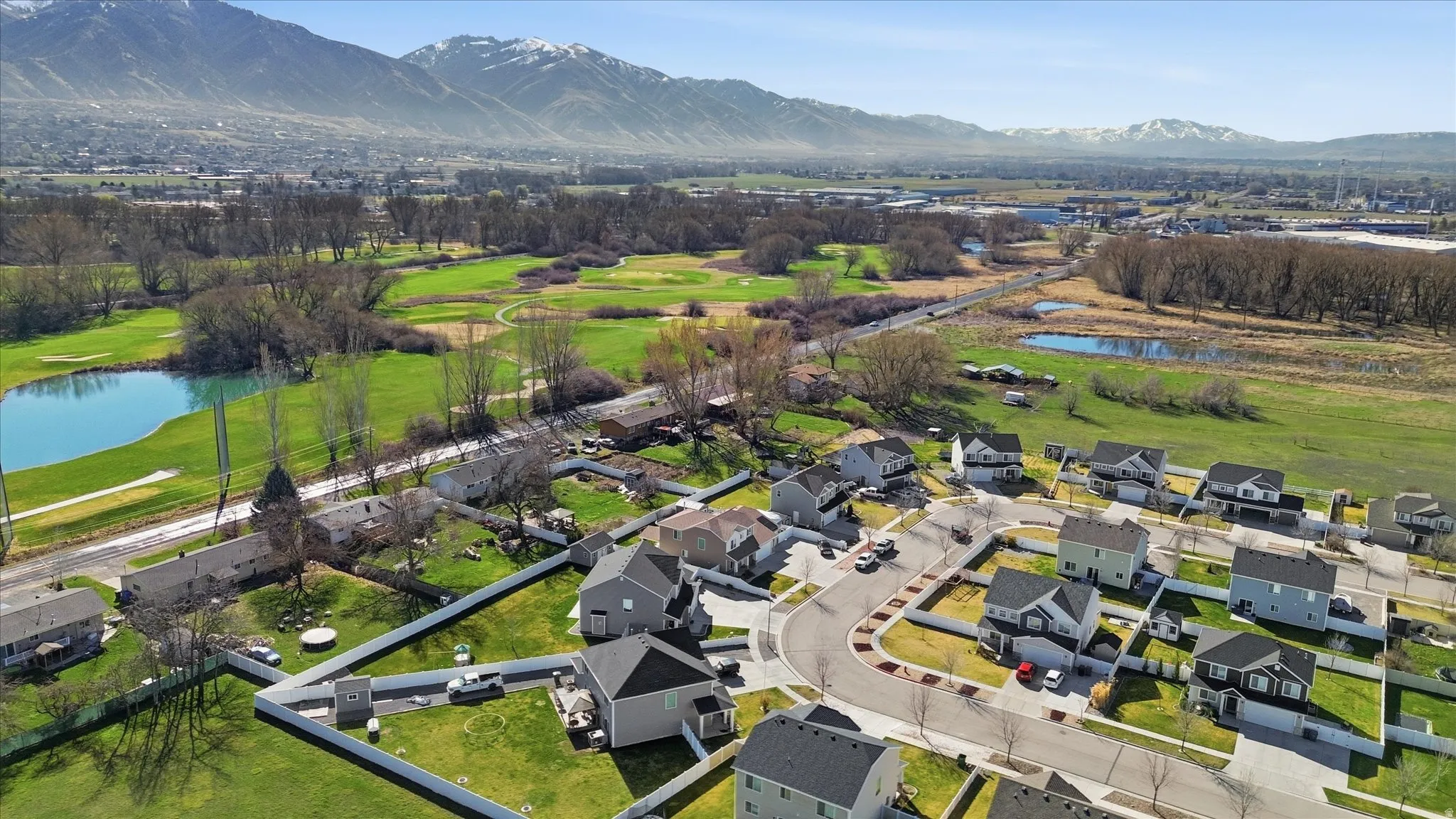 Aerial view of residential area featuring a water and mountain view and a local golf course