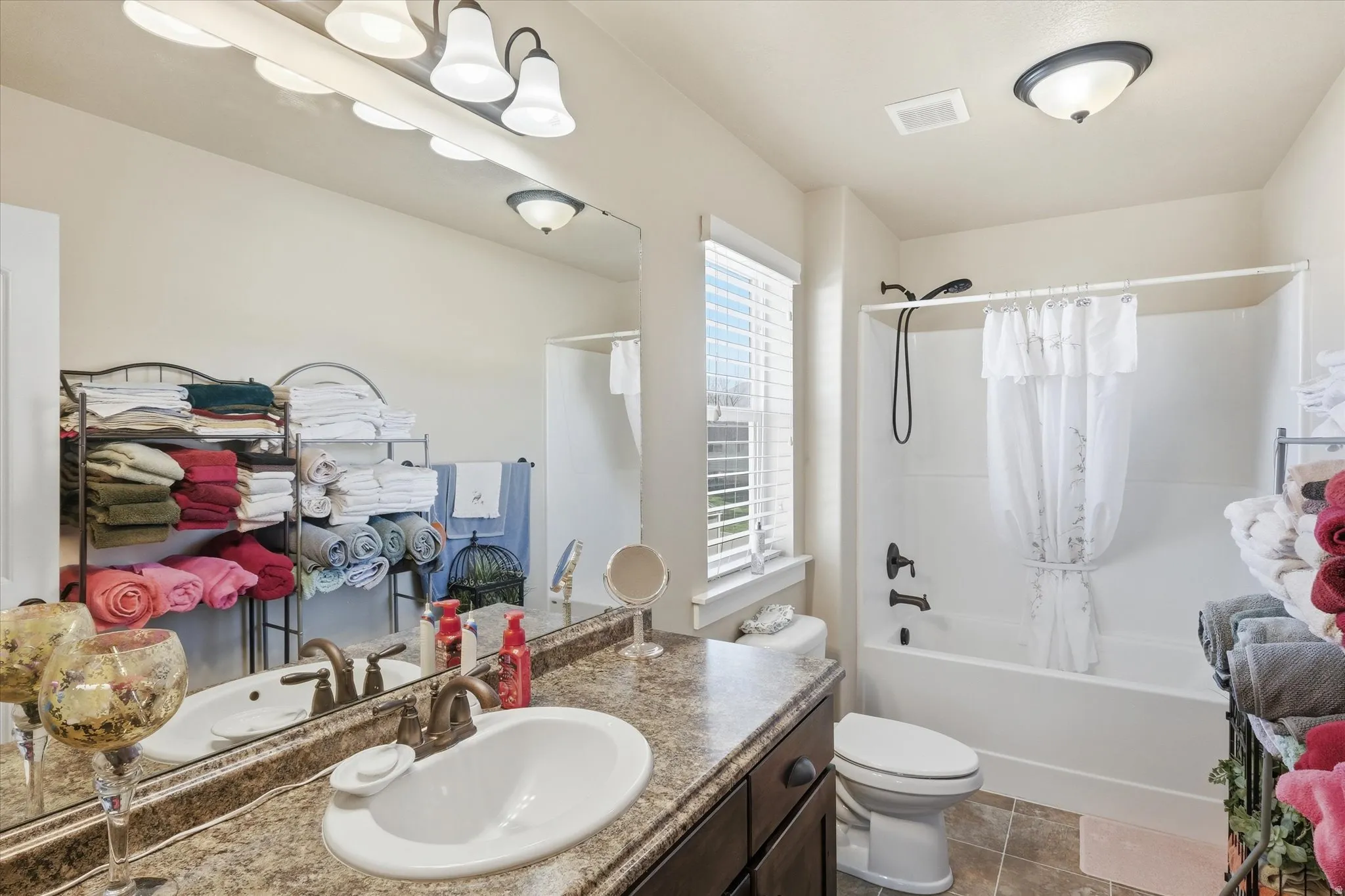 Bathroom with vanity and shower / tub combo with curtain