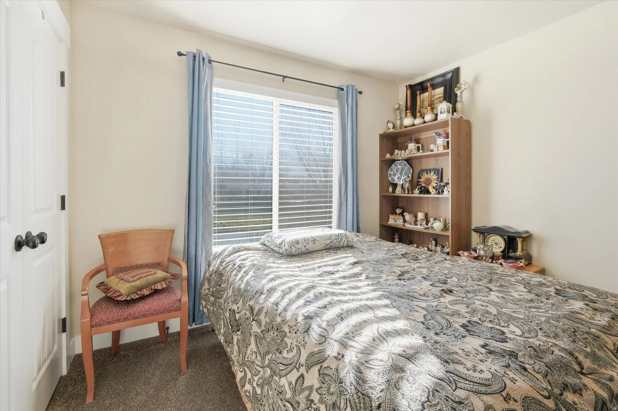 Bedroom featuring dark carpet and a closet
