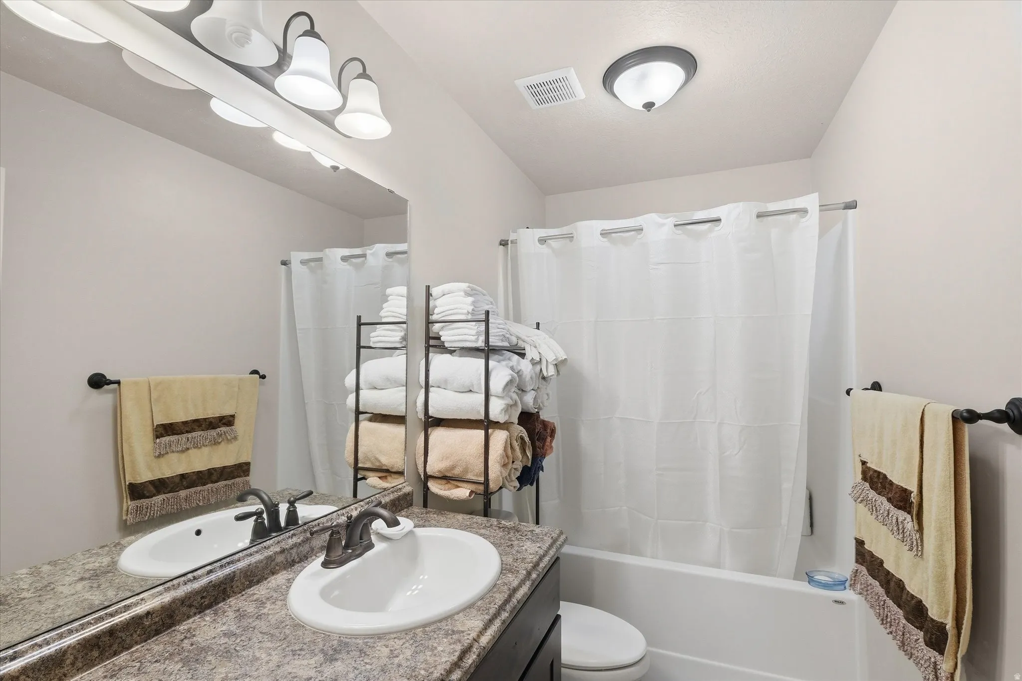 Bathroom featuring vanity and shower / bath combo
