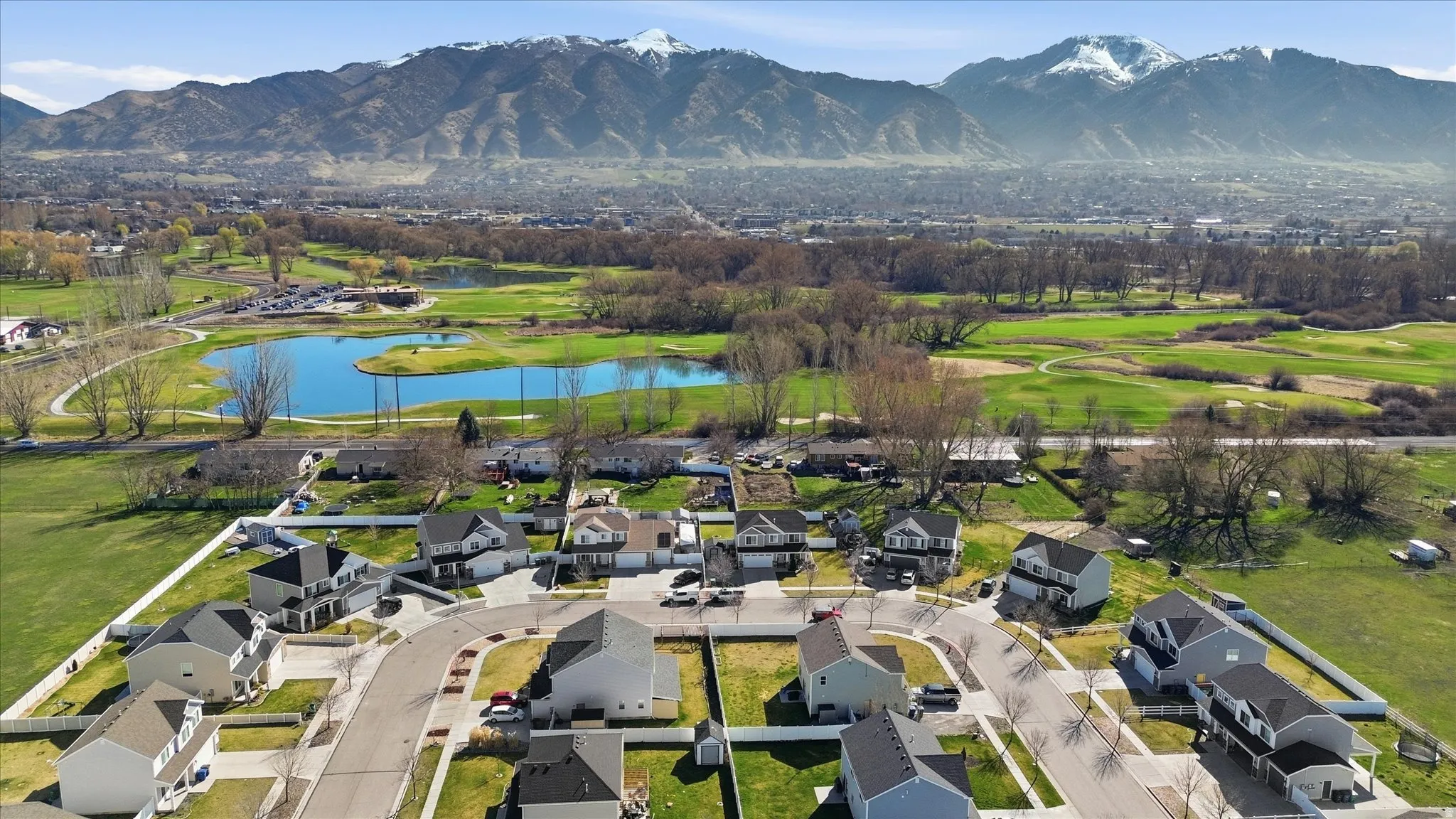 Aerial view of residential area featuring a water and mountain view and a golf course