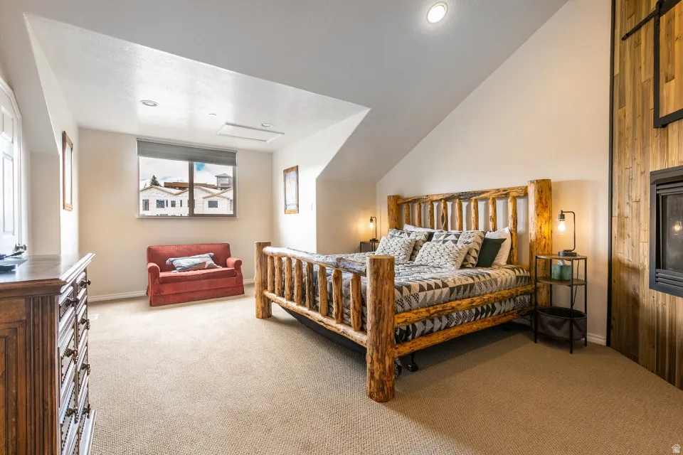 Bedroom with light carpet and baseboards
